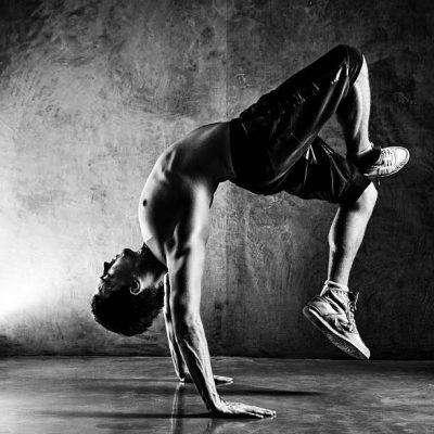 Young man sports exercises. Contrast black and white.