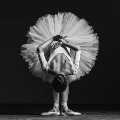 Young beautiful dancer is posing in studio